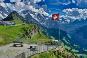 a viewing deck with swiss flag in grindelwald switzerland